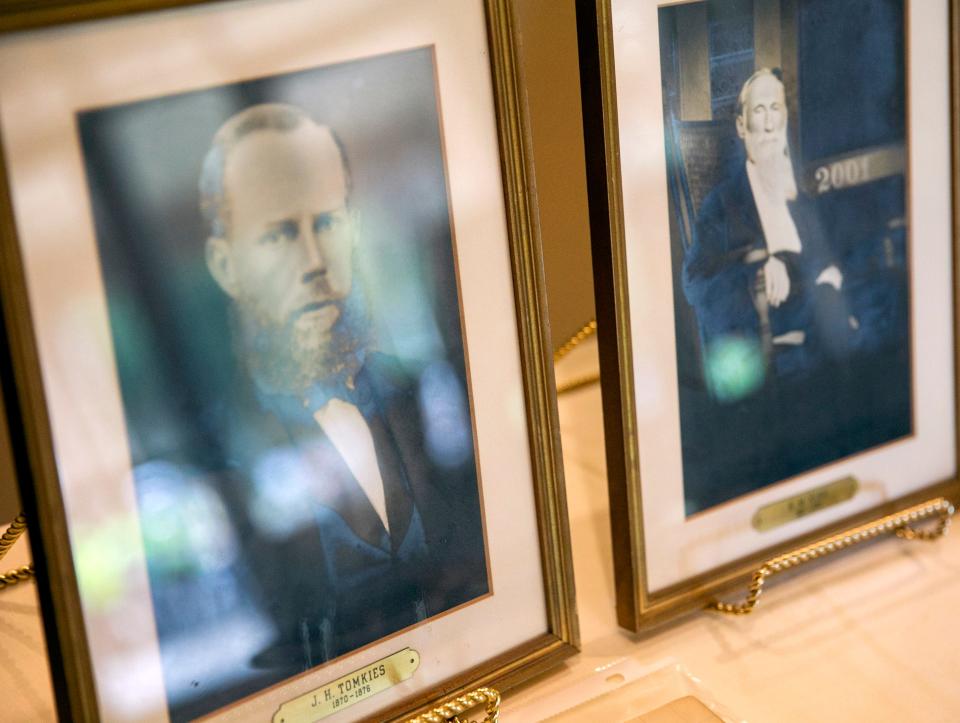 Photos of the founding members of First Baptist Church Gainesville are displayed inside the current church during its weekend long 150th anniversary celebration on Saturday. Along with historical artifacts of the church’s history, there were activities for kids and an antique car show. [Cyndi Chambers/Special to the Sun] 2022