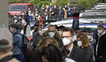 Several hundreds of people line up to receive an AstraZeneca vaccination against the coronavirus at the forum of the DITIB central mosque in Cologne, Germany, Saturday, May 8, 2021. (AP Photo/Martin Meissner)