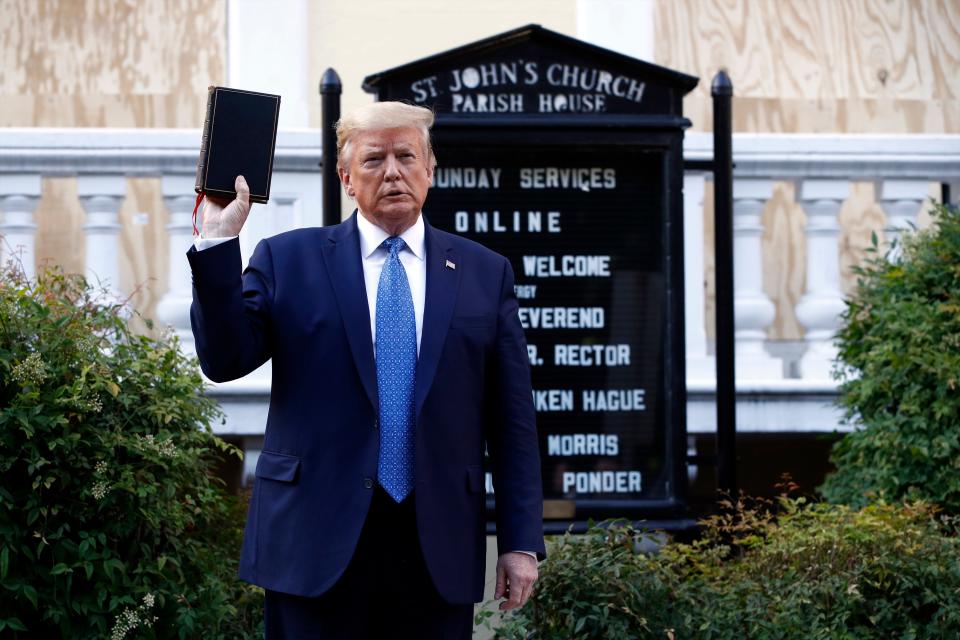 President Donald Trump holds a Bible as he visits outside St. John's Church across Lafayette Park from the White House, June 1, 2020, in Washington. Part of the church was set on fire during protests on Sunday night.