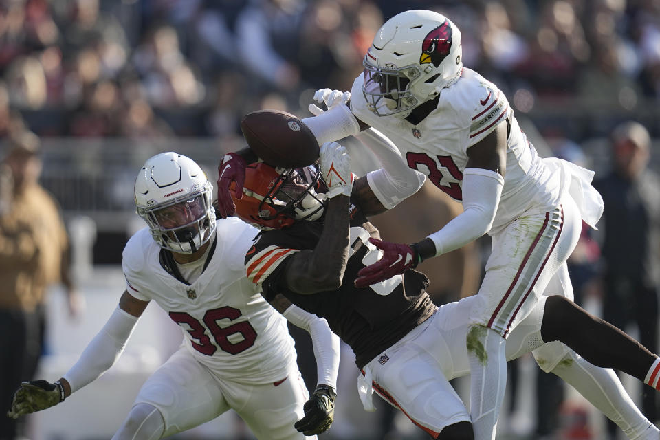 Cleveland Browns wide receiver Marquise Goodwin, middle, cannot catch a pass between Arizona Cardinals safety Andre Chachere (36) and cornerback Garrett Williams during the second half of an NFL football game Sunday, Nov. 5, 2023, in Cleveland. (AP Photo/Sue Ogrocki)