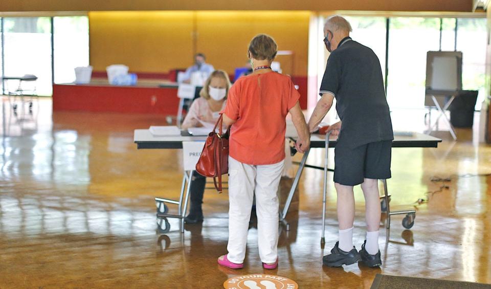 Mary and John Maguire vote in the Milton town election at the Cunningham Community Center.