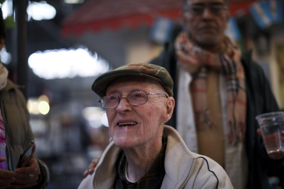 In this Aug. 15, 2019 photo, James McManus, 99, smiles during an interview in Buenos Aires, Argentina. After fighting in WWII, he worked as a Navy radio operator, a position that allowed him to travel the world and meet many people. But the tango transformed his life, he said, and made him a happier person. (AP Photo/Natacha Pisarenko)