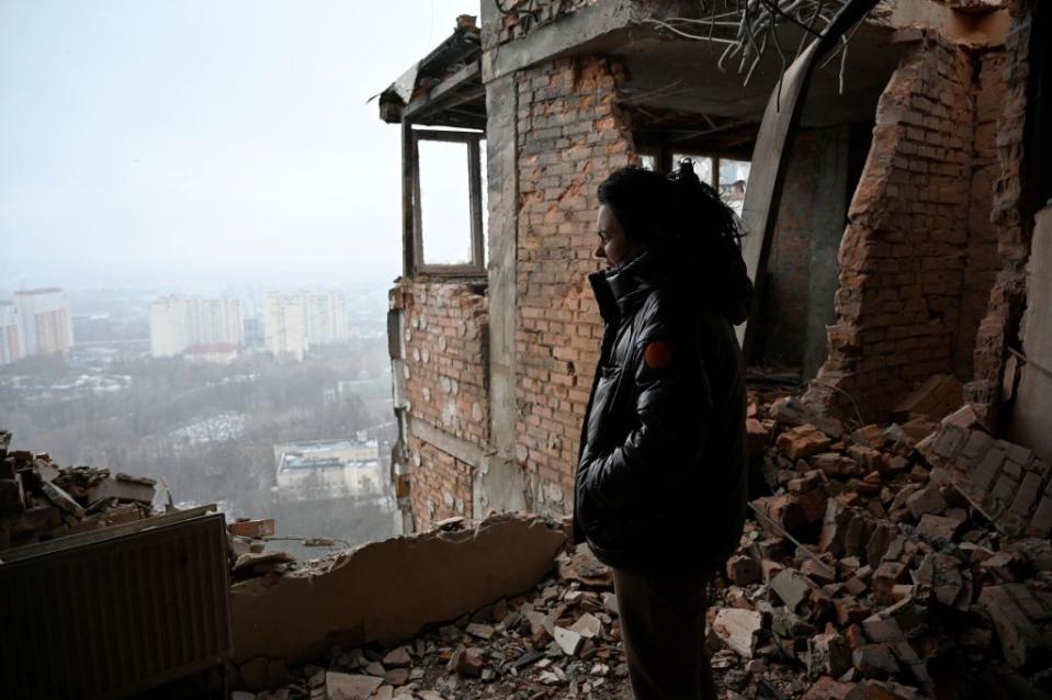 local resident inspects the damage at a multi storey