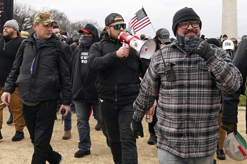 FILE - Proud Boys members including Zachary Rehl, left, Ethan Nordean, center, and Joseph Biggs, walk toward the U.S. Capitol in Washington, in support of President Donald Trump on Jan. 6, 2021. (AP Photo/Carolyn Kaster, fFle)