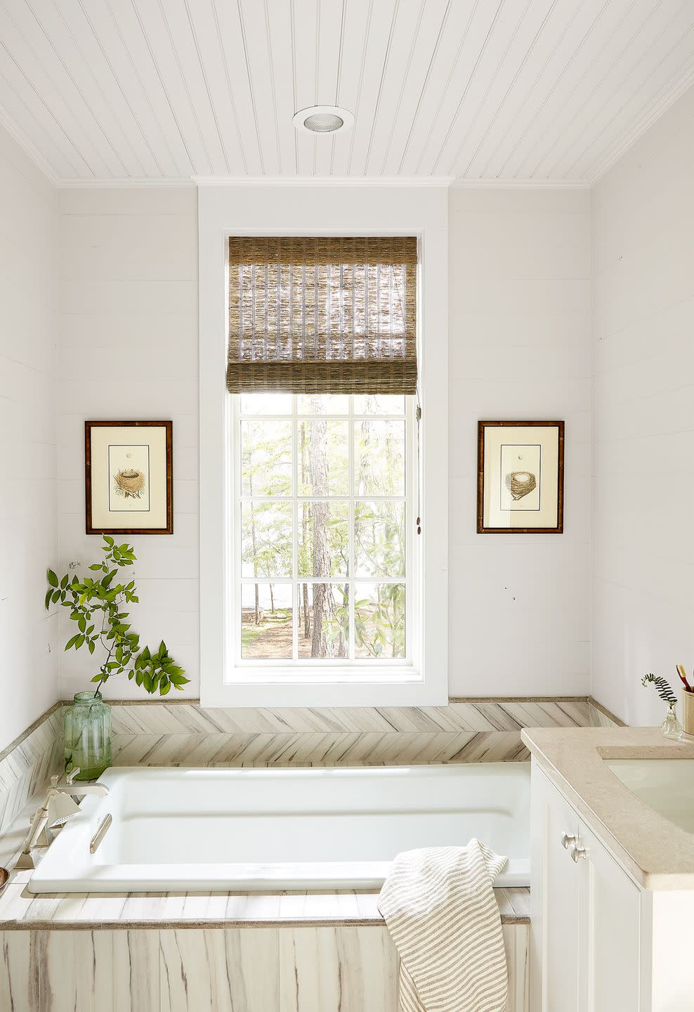 bathroom with herringbone tile surround on tub