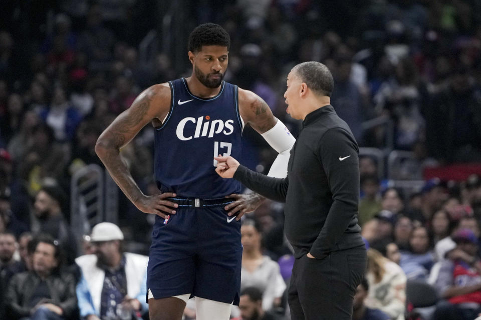 Los Angeles Clippers forward Paul George, left, speaks with coach Tyronn Lue during the first half of the team's NBA basketball game against the Washington Wizards, Friday, March 1, 2024, in Los Angeles. (AP Photo/Ryan Sun)