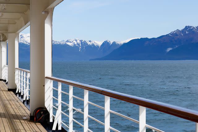 <p>Janice Chen/Getty Images</p> View of Alaskan Mountains off the side of a cruise ship.