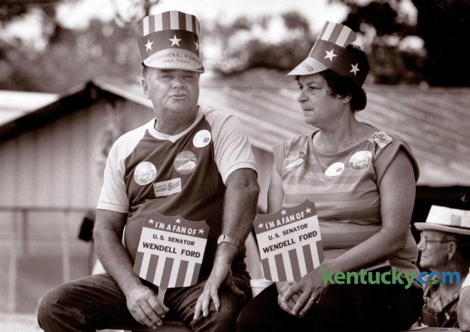 Randle Darnell and Marge Eastin, both of Benton, showed their support for Wendell Ford and other candidates as they waited for the speeches to begin at the 1986 Fancy Farm picnic.