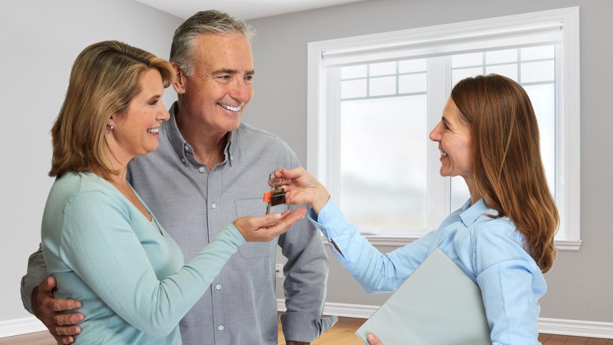 Senior couple with realtor.