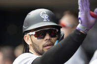 Colorado Rockies first baseman Connor Joe is congratulated by teammates after scoring against the Minnesota Twins in the first inning of a baseball game Sunday, June 26, 2022, in Minneapolis. (AP Photo/Andy Clayton-King)