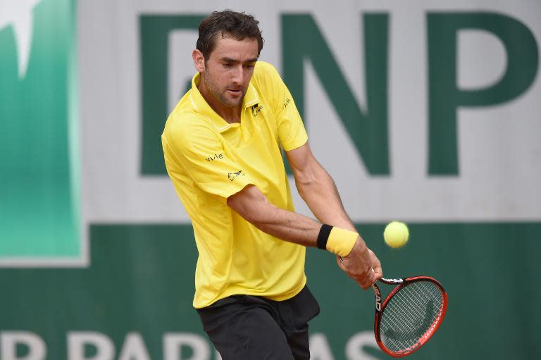 Marin Cilic returns the ball to Andrea Arnaboldi at Roland Garros on May 28, 2015