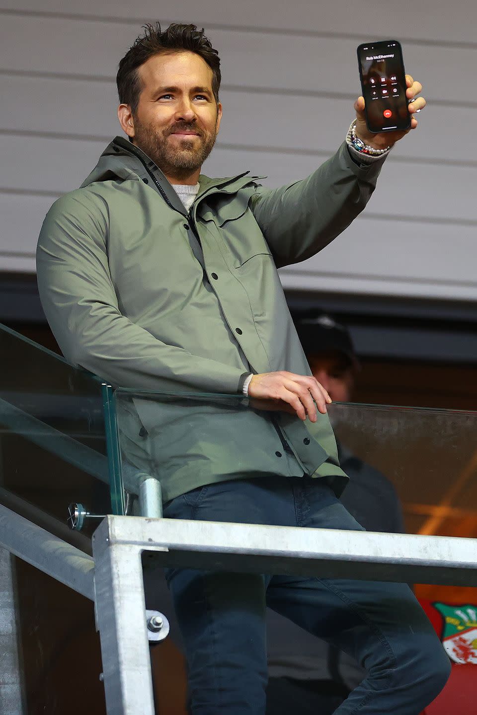 ryan reynolds holding up a cell phone showing rob mcelhenney as the other caller