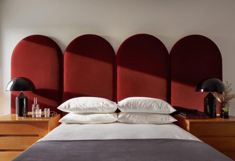 <p>The headboard is the natural focal point of a bedroom, and with its architectural curves and pop of crimson, this curved design by London interior studio No.12 commands attention. ‘Plain but polished fabrics, such as velvets in rich tones, create a sophisticated, timeless effect,’ say founders Katie and Emma.<br></p>