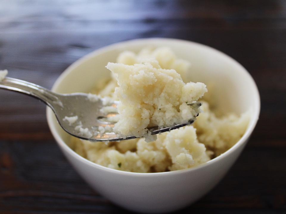 bells sour cream and chive mashed potatoes in a white bowl with fork