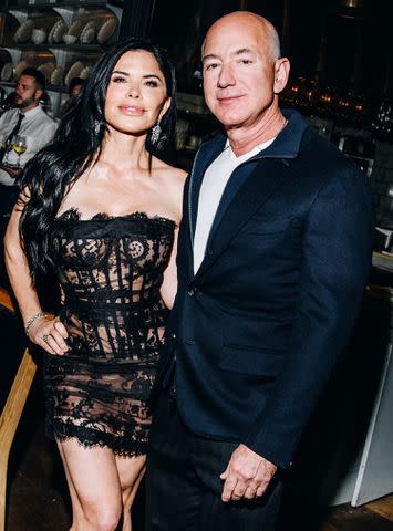 <p>Nina Westervelt/WWD via Getty Images</p> Lauren Sanchez and Jeff Bezos attend the Monse Maison Pre-Met Cocktail Celebration on May 5, 2024