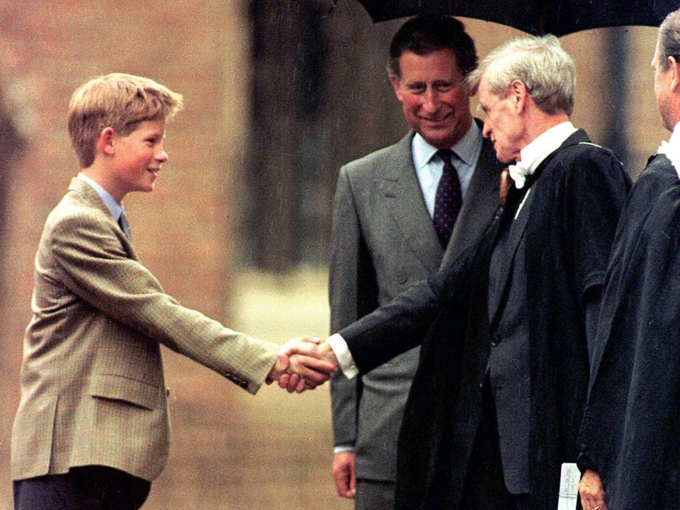 Prince Harry meets Headmaster John Lewis, right, as Prince Charles looks on, after his arrival at the prestigious Eton college Wednesday, Sept. 2, 1998. Prince Harry will join his older brother William as a boarder at the elite school.