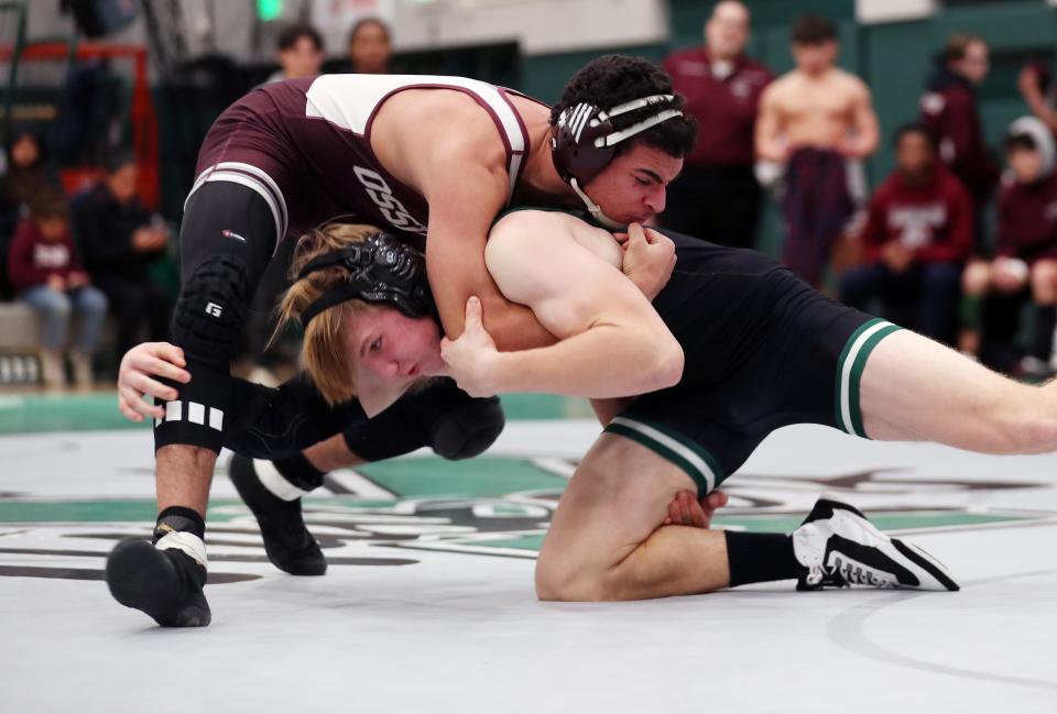 Ossining's Sal DiSenso, top, pictured against Yorktown's Ronan Forde in a dual meet on Dec. 21, 2023.