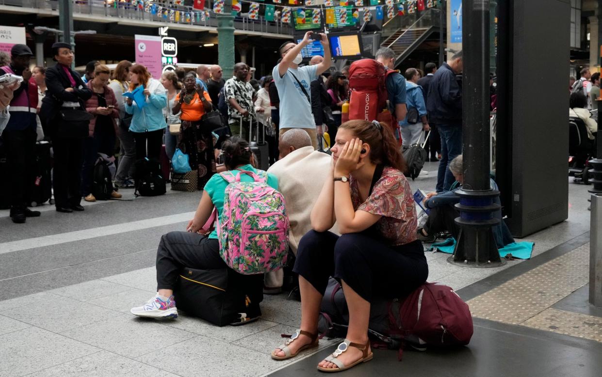 A traveller waits inside the Gare du Nord train station at the 2024 Summer Olympics, Friday, July 26