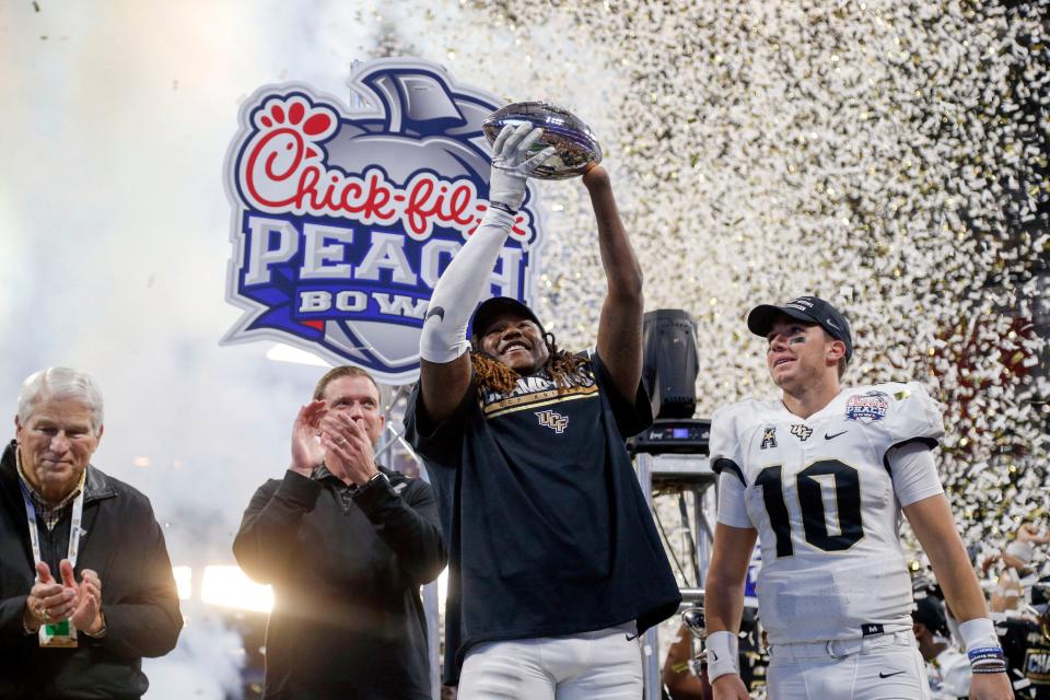 Shaquem Griffin lifts the Peach Bowl trophy after UCF completed an undefeated 2017 season with a 34-27 win over Auburn, coached at the time by Gus Malzahn.