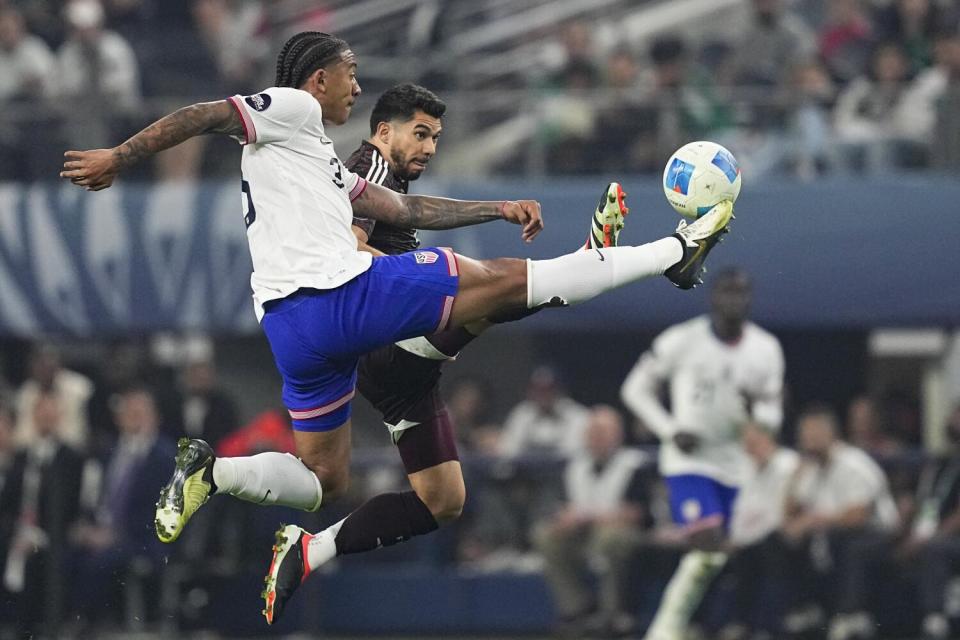 U.S. defender Chris Richards, left, battles Mexico forward Henry Martin for the ball during the Nations League final.