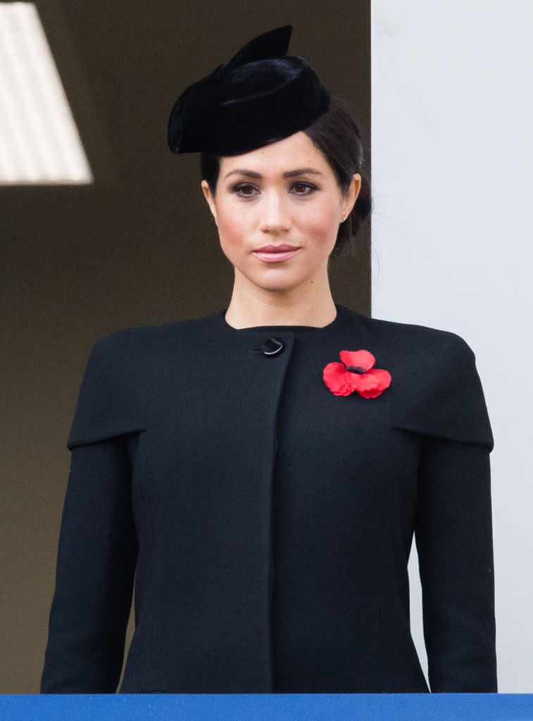 <p>For her debut Remembrance Service in London, Meghan wore a bespoke outfit by Givenchy. She finished the all-black ensemble with a co-ordinating headpiece and poppy. <em>[Photo: Getty]</em> </p>