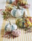 <p>Craft your own personal pumpkin patch using old quilts and fabric scraps.</p><p><strong>To make:</strong> Start with a round piece of fabric and a ball of batting (about the size you want your finished pumpkin to be). Gather the fabric up around the batting and hot glue it together in the center. Collect dried stems, or purchase faux stems, and attach with hot glue for a realistic touch. Line the middle of a long farmhouse table with a runner, then pile on your creations and other seasonal greenery. These would be an adorable accent to a mantel or buffet as well.</p><p><a class="link " href="https://www.amazon.com/s?k=pumpkin+stems&i=handmade&ref=nb_sb_noss_2&tag=syn-yahoo-20&ascsubtag=%5Bartid%7C10050.g.2063%5Bsrc%7Cyahoo-us" rel="nofollow noopener" target="_blank" data-ylk="slk:SHOP FAUX PUMPKIN STEMS;elm:context_link;itc:0;sec:content-canvas">SHOP FAUX PUMPKIN STEMS</a></p>