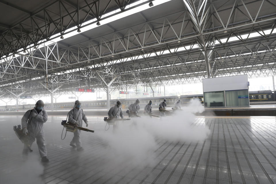 In this March 24, 2020, photo released by Xinhua News Agency, firefighters conduct disinfection on the platform at Yichang East Railway Station in Yichang, in central China's Hubei Province, March 24, 2020. China is re-opening some train stations and bus service as it lifts a lockdown in Hubei province to stem the spread of a new coronavirus. The provincial railway group said that stations would open in all cities except Wuhan on Wednesday. (Photo by Wang Shen/Xinhua)