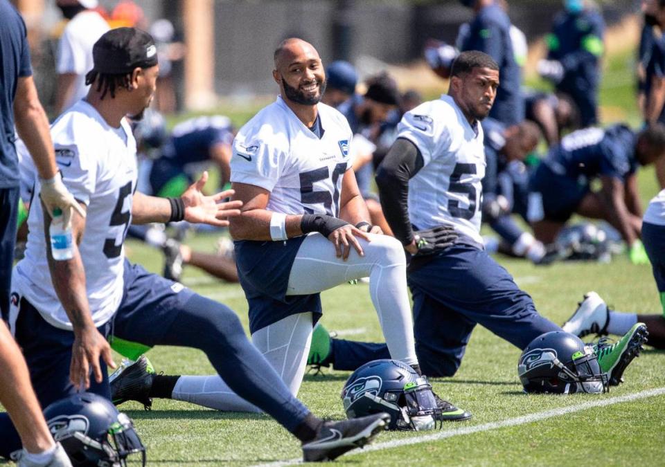 Seattle’s best known defensive players stretch together Thursday. From left, Bruce Irvin, K.J. Wright and Bobby Wagner. The Seattle Seahawks practiced Thursday, August 13, 2020 at the VMAC in Renton, WA.