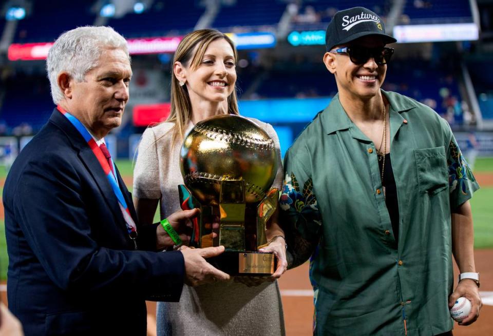 From left to right: Commissioner Juan Francisco Puello, President, Confederacion de Beisbol, Miami Marlins President of Business Operations Caroline O’Connor and Puerto Rican rapper Daddy Yankee hold the Serie del Caribe trophy before the start of an MLB game between the Miami Marlins and the Chicago Cubs at loanDepot park on Saturday, April 29, 2023, in Miami, Fla.