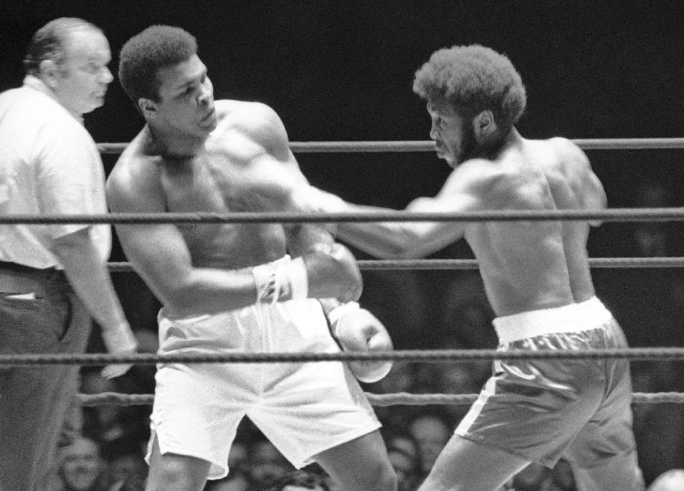 FILE - In this July 27, 1971, file photo, Referee Jay Edson, left, keeps an eye on the fight between Muhammad Ali and Jimmy Ellis, right, in the 12th round of their heavyweight fight in Houston. Ellis, a former heavyweight boxing champion who trained with fellow Louisville fighter Muhammad Ali and squared off against some of his era's best fighters, has died in his hometown Tuesday, May 6, 2014. He was 74. Ellis' brother, Jerry, said the ex-champion died at a Louisville hospital Tuesday after suffering from Alzheimer's disease in recent years. (AP Photo/File)