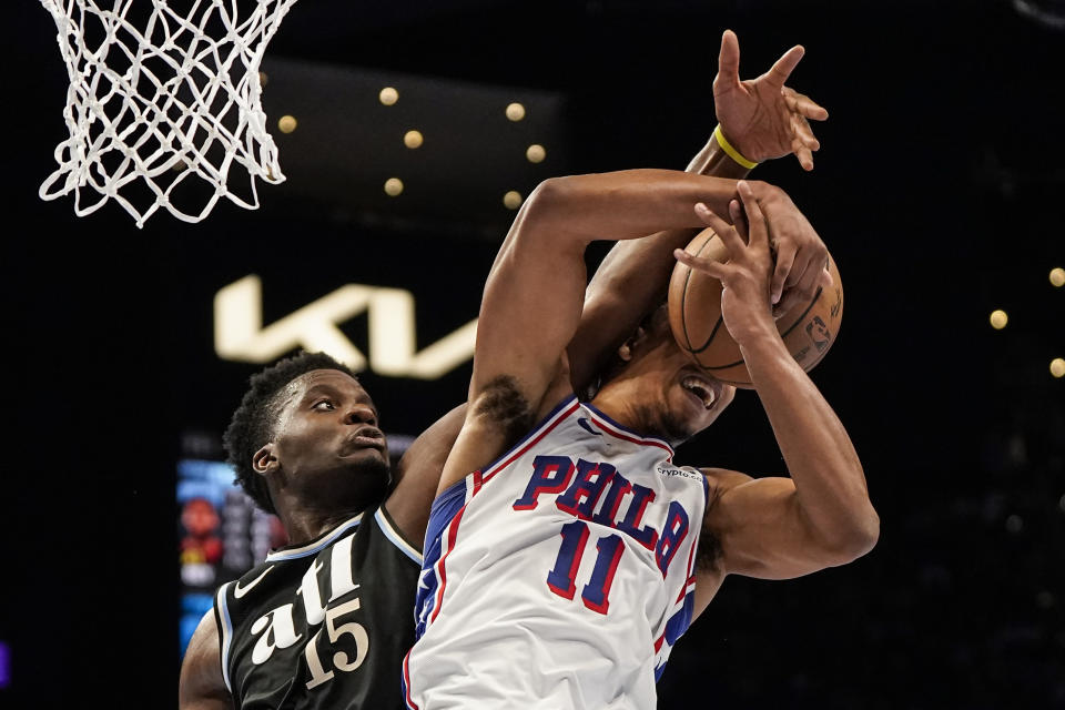 Atlanta Hawks center Clint Capela (15) blocks a shot on Philadelphia 76ers guard Jaden Springer (11) during the second half of an In-Season Tournament NBA basketball game, Friday, Nov. 17, 2023, in Atlanta. (AP Photo/Mike Stewart)