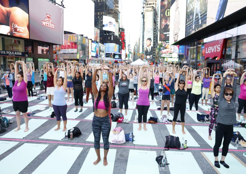People attend a yoga class in celebration of the summer solstice at the 22nd annual all-day outdoor yoga event in Times Square in New York on Thursday. Photo by John Angelillo/UPI