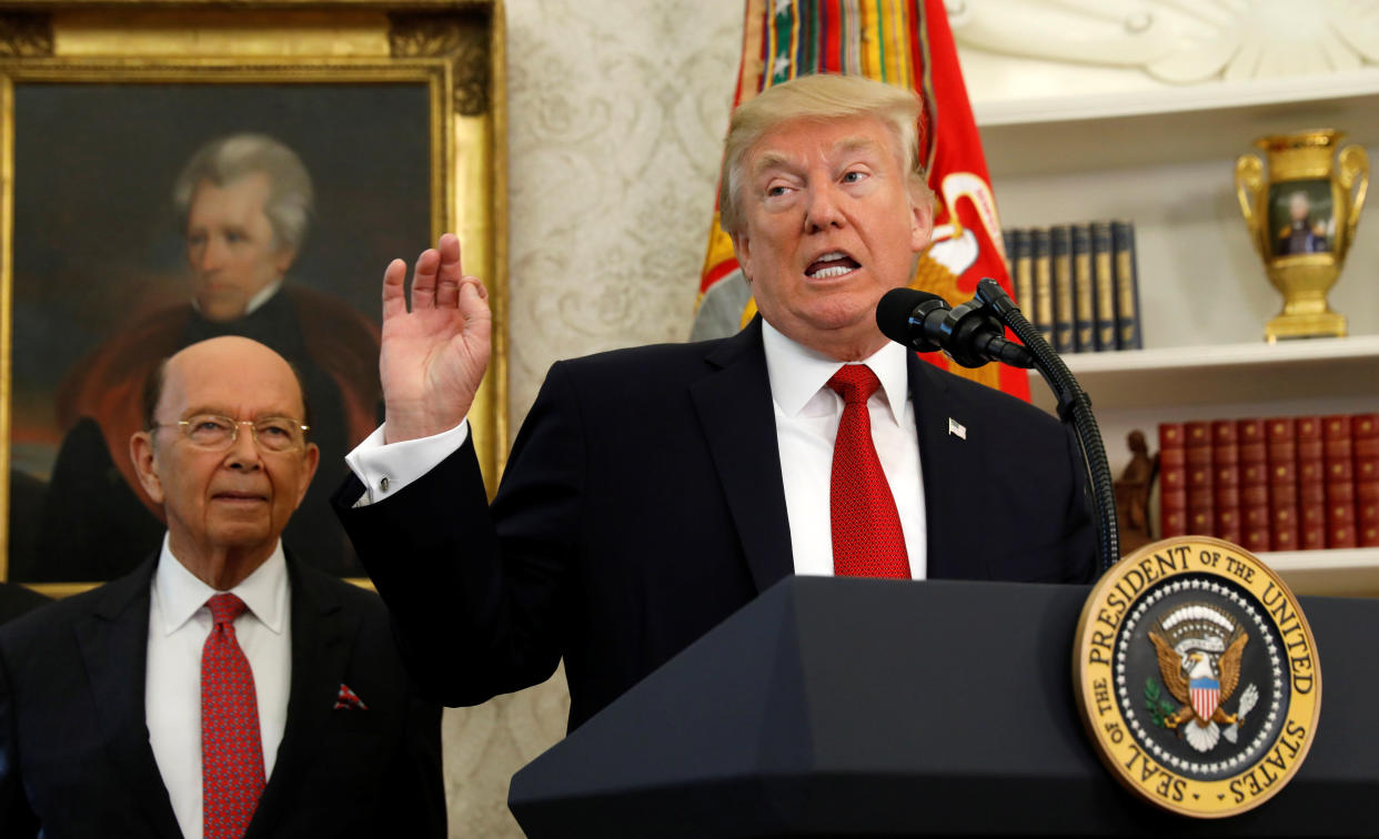 Commerce Secretary Wilbur Ross stands behind President Donald Trump, who speaks at the Minority Enterprise Development Week White House awards ceremony on Oct. 24. (Photo: Kevin Lamarque / Reuters)