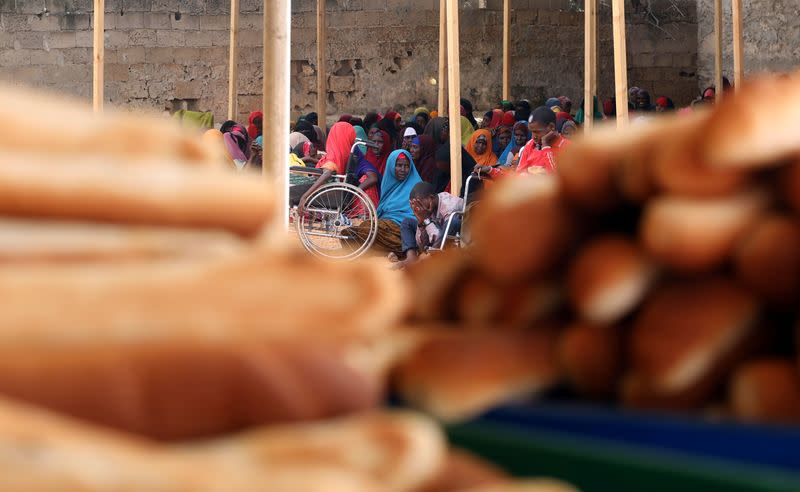 FILE PHOTO: Somali displaced people wait to receive iftar charity food on the first day of the holy fasting month of Ramadan, in Mogadishu