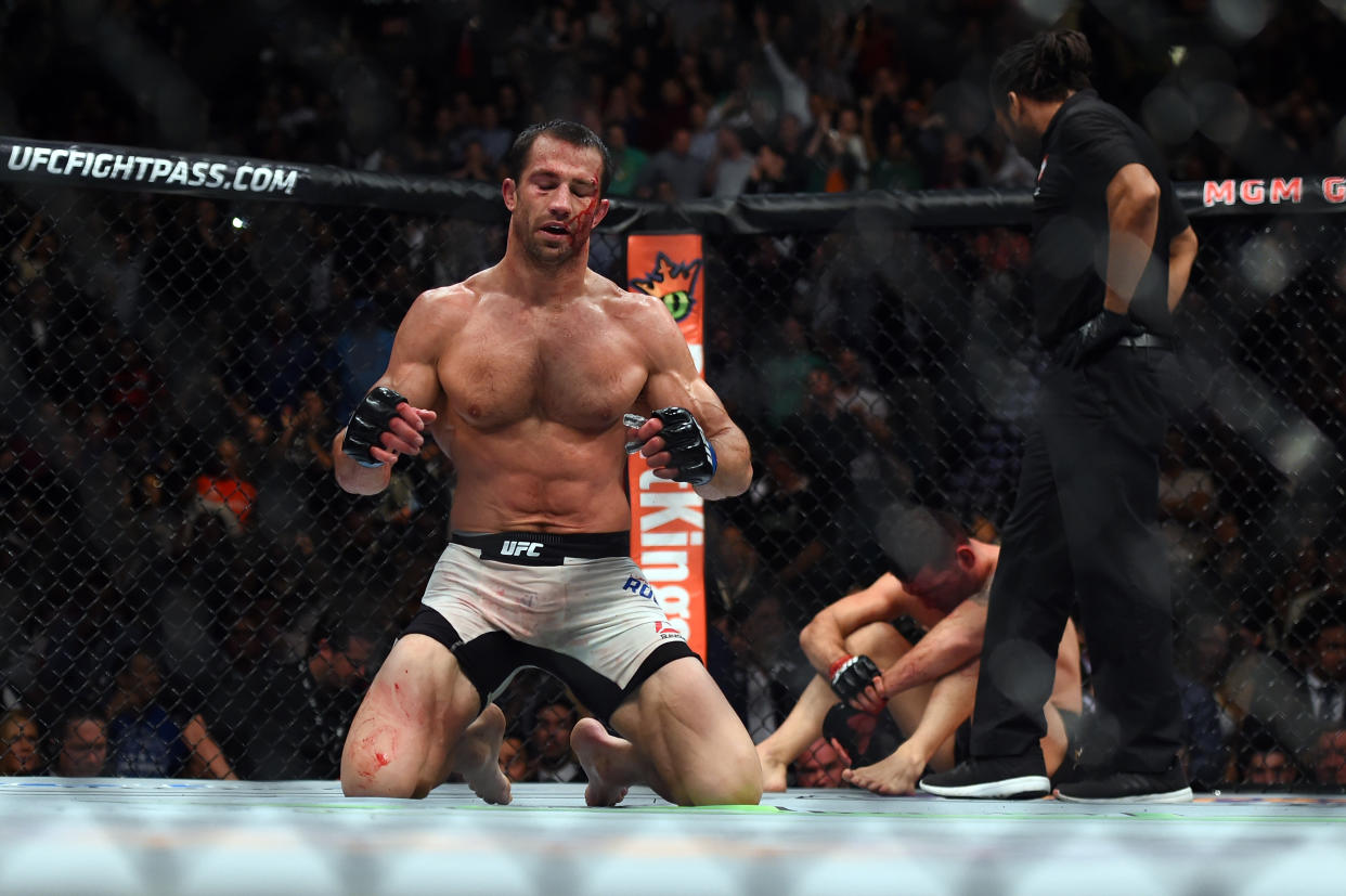 LAS VEGAS, NEVADA - DECEMBER 12:  (L-R) Luke Rockhold celebrates after defeating Chris Weidman in their middleweight championship bout during the UFC 194 event inside MGM Grand Garden Arena on December 12, 2015 in Las Vegas, Nevada.  (Photo by Jeff Bottari/Zuffa LLC/Zuffa LLC via Getty Images)