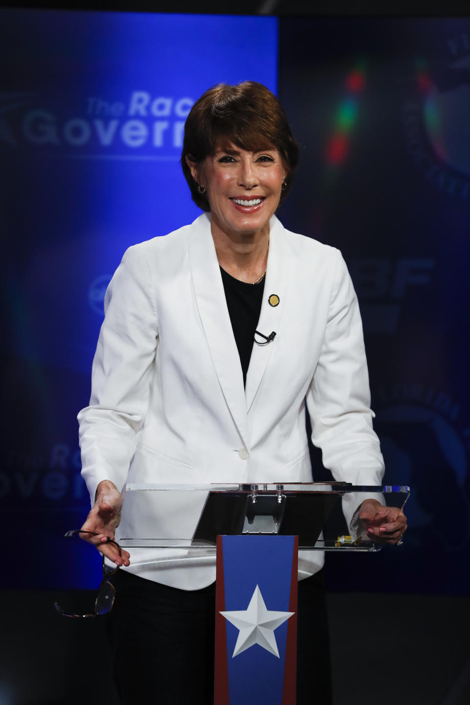 Democratic gubernatorial candidate Gwen Graham awaits the start of a debate ahead of the Democratic primary for governor, Thursday, Aug. 2, 2018, in Palm Beach Gardens, Fla. (AP Photo/Brynn Anderson)
