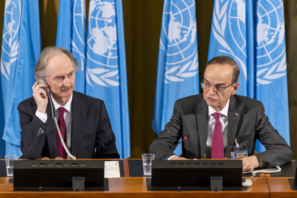 Geir O. Pedersen, left, Special Envoy for Syria and the Constitutional Committee Co-Chairman, Hadi al-Bahra, right, representative of the Syrian opposition, speak during the first meeting of the Syrian Constitutional Committee at the European headquarters of the United Nations in Geneva, Switzerland, Wednesday, October 30, 2019. (Martial Trezzini/Keystone via AP)