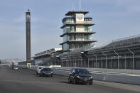 This photo provided by Indianapolis Motor Speedway shows the funeral procession for Aldo Andretti, twin brother of Mario Andretti, taking a lap around the track before funeral services Wednesday, Jan. 13, 2021. Mario feels the same pain as so many others these days. His wife died two years ago, long before the pandemic. And his beloved nephew lost a brutal battle with colon cancer. But then COVID-19 claimed his twin brother Aldo and one of the greatest racers of all time is not immune from the loneliness and depression sweeping the world. (Chris Owens/Courtesy IMS Photo via AP)