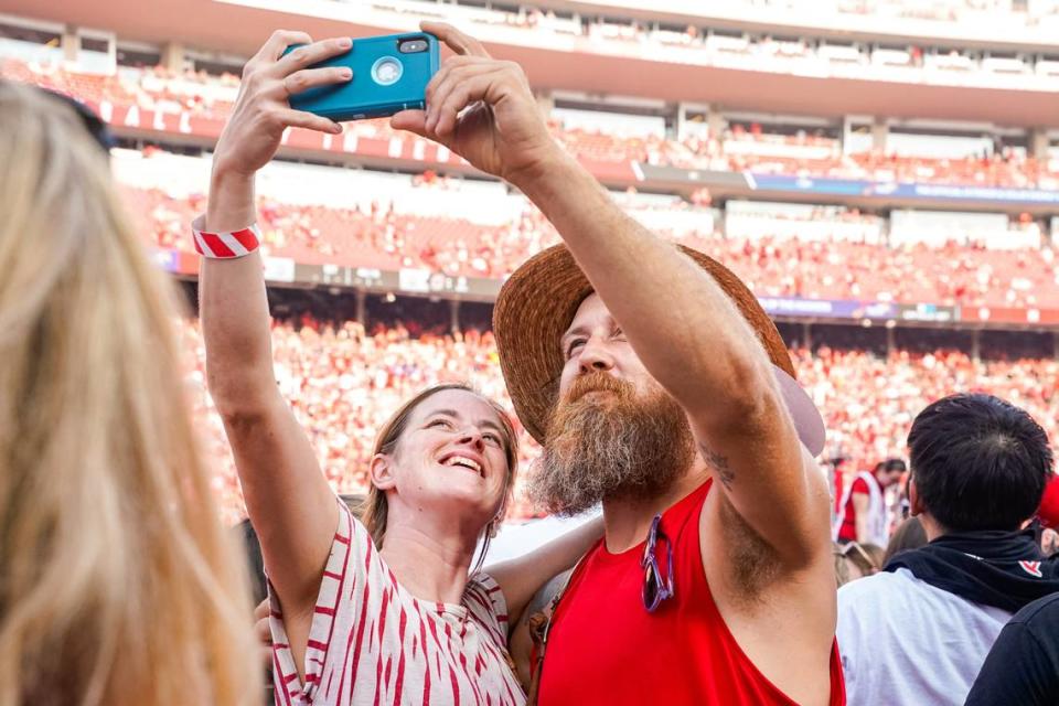Fans take a photo before the game between the Nebraska Cornhuskers and the Omaha Mavericks at Memorial Stadium.