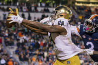 FILE - Notre Dame wide receiver Kevin Austin Jr. (4) makes a touchdown catch ahead of Virginia defensive back Anthony Johnson (3) in the second half an NCAA college football game on Saturday, Nov. 13, 2021, in Charlottesville, Va. Notre Dame is No. 5 in The Associated Press preseason college football poll, released Monday, Aug. 15, 2022. (AP Photo/Mike Caudill, File)