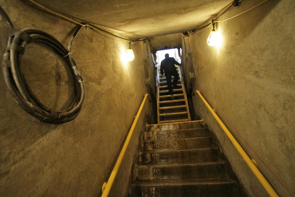 FILE- In this April 12, 2007 file photo, a Metropolitan Transit Authority employee climbs the stairs to the street from the partly finished track of the 2nd Avenue subway prior to the ground breaking ceremony in New York. Construction first started 45 years ago, but New Yorkers' long wait to take a subway under Manhattan's far Upper East Side ends at noon Sunday, Jan. 1, 2017, when a stretch of the new Second Avenue line is set to open to the public. (AP Photo/Mary Altaffer, File)