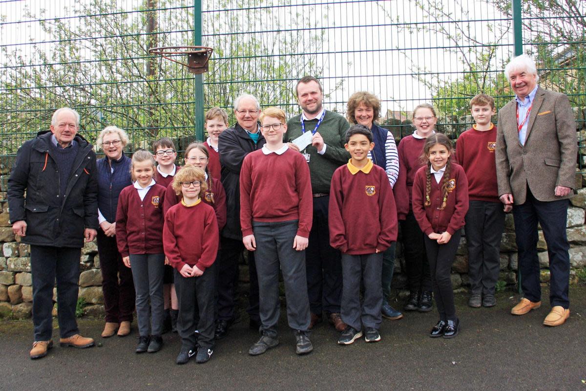 Northallerton club chairman, Bill Pye, teaching assistant Janet Allison, Northallerton DMC president, Geoff Simpson, headteacher, Matthew Scott, teacher, Rachel Grundman, and Northallerton DMC treasurer, Peter Gregory, with pupils at Chop Gate