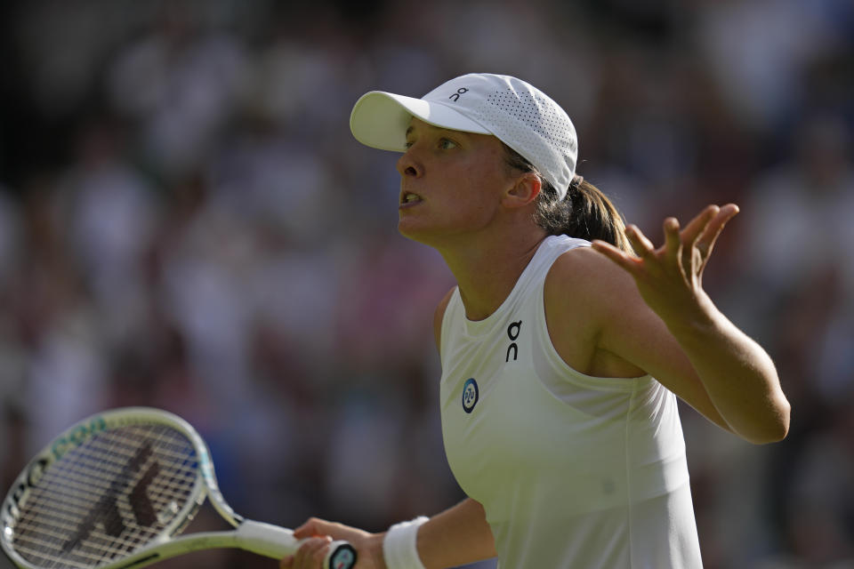 Poland's Iga Swiatek reacts after losing a point to Switzerland's Belinda Bencic in a women's singles match on day seven of the Wimbledon tennis championships in London, Sunday, July 9, 2023. (AP Photo/Kirsty Wigglesworth)