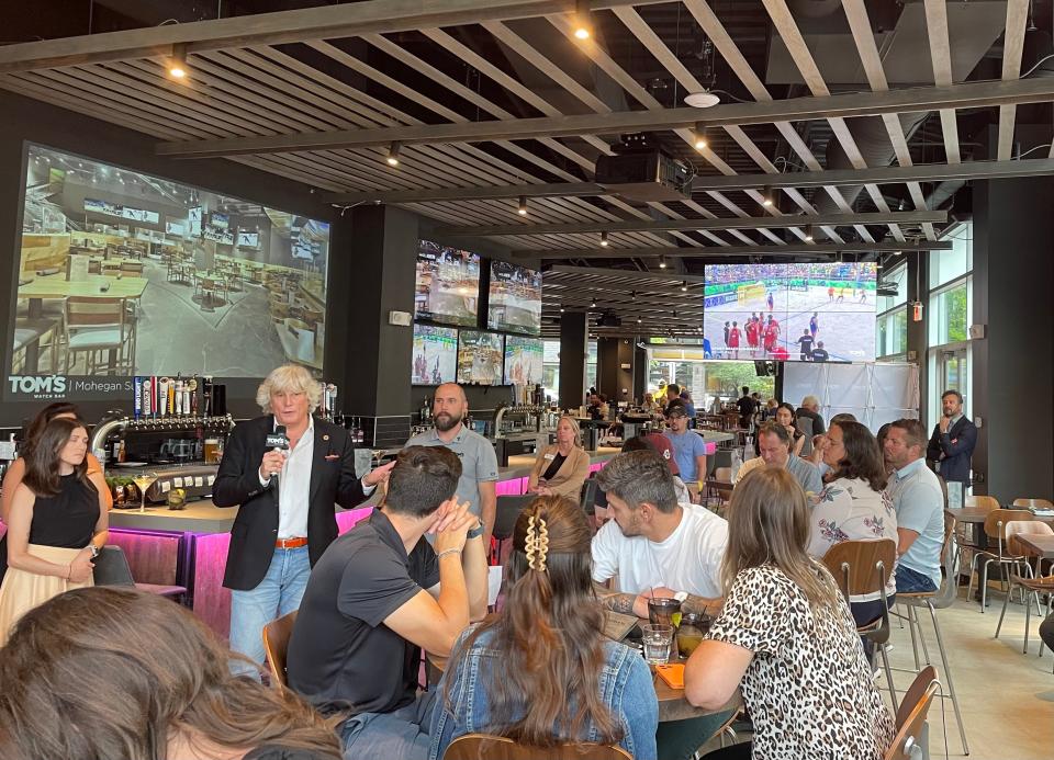 Tom Ryan addresses the crowd at his Pittsburgh restaurant's grand opening.