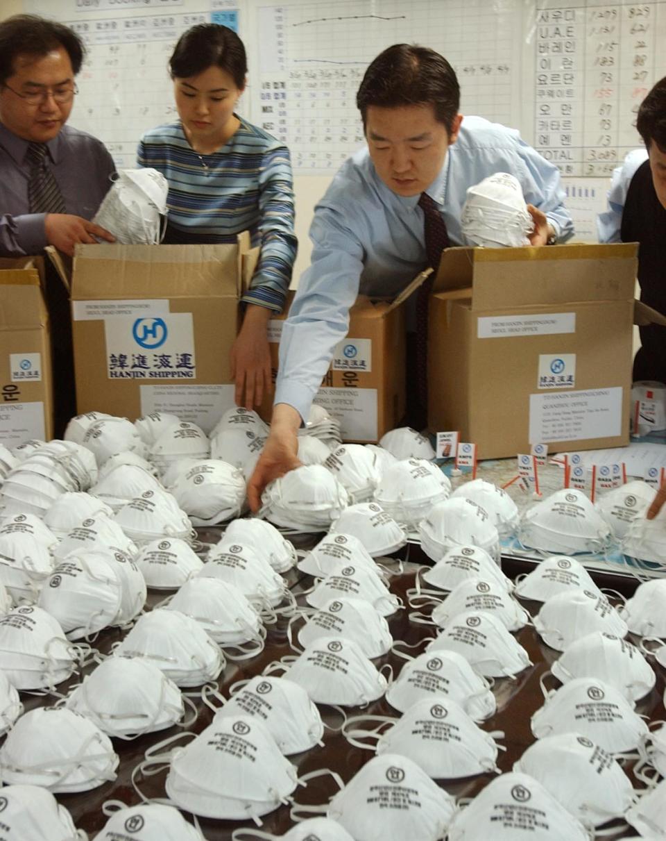 Employees of South Korea's Hanjin Shipping Company pack masks for the company's overseas staff as a precaution against possible infection by the deadly disease, SARS, at the company office in Seoul, South Korea, Thursday, April 3, 2003.