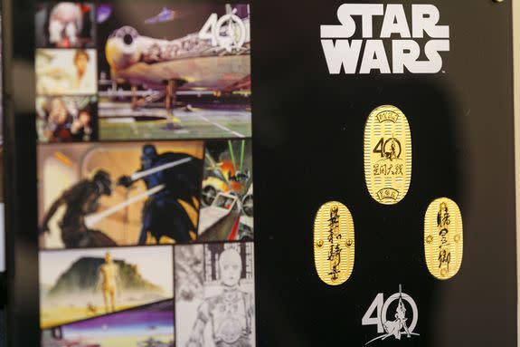 Mandatory Credit: Photo by Aflo/REX/Shutterstock (8628464p) Commemorative 24k gold coins of the film series Star Wars inscribed with the Japanese word for ''Jedi'' (L) and ''Darth Vader'' (R) are on display at the Ginza Tanaka jewelry store 24k gold mask of Darth Vader goes on sale, Ginza Tanaka jewelry store, Tokyo, Japan - 25 Apr 2017 To the celebrate the 40th anniversary of the series of Star Wars, the Japanese jewelry store is selling a life-size mask of Darth Vader made from 15kg of pure 24k gold. The Mask is valued at approximately 1.4 million US Dollars. The store is also selling sets of 24k gold commemorative coins with prices ranging from USD 1,201 to 11,124. The products will go on sale on Star Wars Day, May 4th.