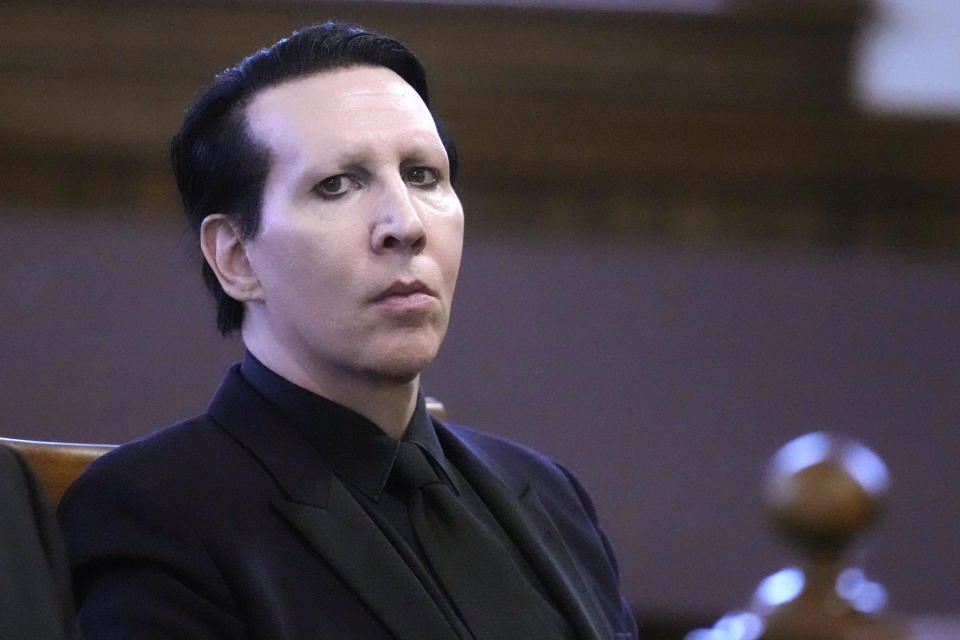 Musical artist Marilyn Manson, whose legal name is Brian Hugh Warner, waits for the judge to arrive in Belknap Superior Court,Monday, Sept. 18, 2023, in Laconia, N.H. Manson, who was charged with charged with two misdemeanor counts of simple assault, was accused of approaching a videographer at his 2019 concert in New Hampshire and allegedly spitting and blowing his nose on her. (AP Photo/Charles Krupa)