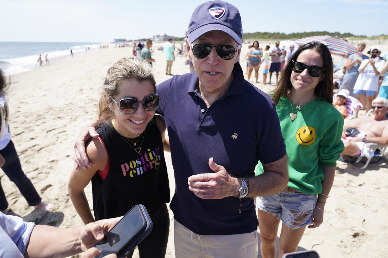 President Joe Biden talks to the media after walking on the beach with his granddaughter Natalie Biden, left, and his daughter Ashley Biden, right, Monday, June 20, 2022 at Rehoboth Beach, Del. (AP Photo/Manuel Balce Ceneta)