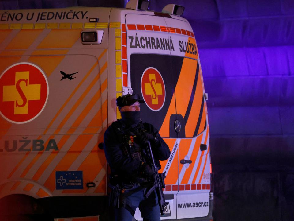 A police officer next to an ambulance near the area of the shooting (REUTERS)