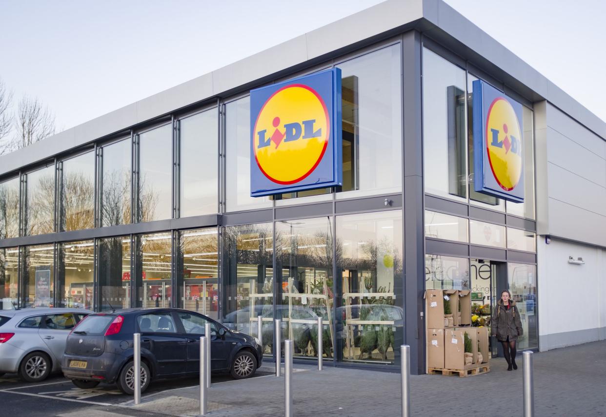 BUCKINGHAM, UK - December 04, 2019. Lidl supermarket store exterior, with woman shopper outside the entrance.